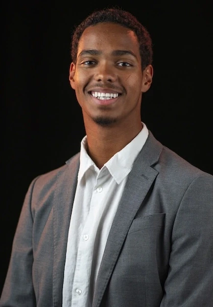 Ephram Otodo in a gray blazer and white shirt